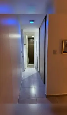 a hallway with a hallway leading to a room with a door at Paseo Quattro Villa Carlos Paz in Villa Carlos Paz