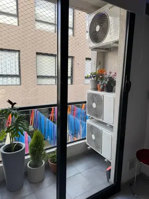 a view of a balcony with a window with a fan at Paseo Quattro Villa Carlos Paz in Villa Carlos Paz