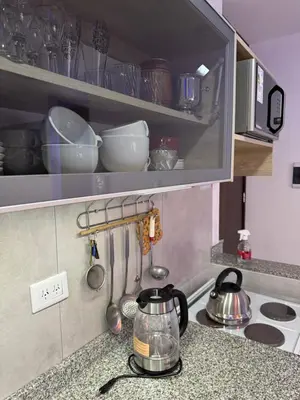 a kitchen counter with a tea kettle and utensils at Paseo Quattro Villa Carlos Paz in Villa Carlos Paz