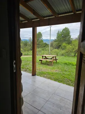 a patio with a picnic table in a field at Las Casitas de Piedra II in Villa General Belgrano