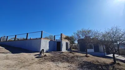 a building with a balcony on top of it at Cabañas Colibri in Las Rabonas