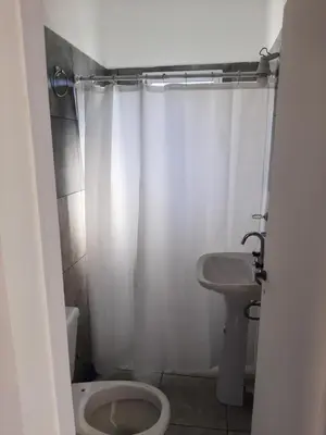 a bathroom with a toilet and a sink at Cabañas Colibri in Las Rabonas