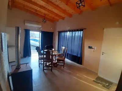 a dining room with a table and chairs in a room at Altura serrana in Villa Yacanto