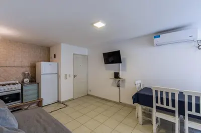 a kitchen with a refrigerator and a table in a room at Depto de confortables ambientes by Lofty in Cordoba