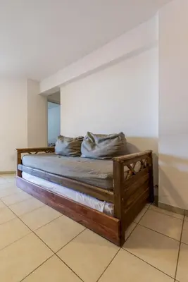 a bedroom with a wooden bed in a room at Depto de confortables ambientes by Lofty in Cordoba