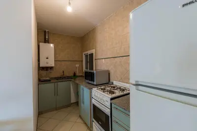 a kitchen with a stove and a microwave at Depto de confortables ambientes by Lofty in Cordoba