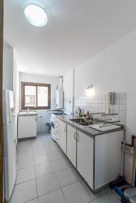 a kitchen with a sink and a refrigerator at Alójate en la Docta by Lofty in Cordoba