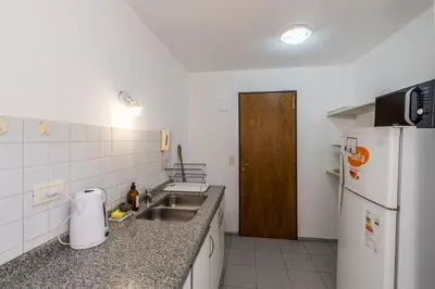 a small kitchen with a sink and a refrigerator at Alójate en la Docta by Lofty in Cordoba