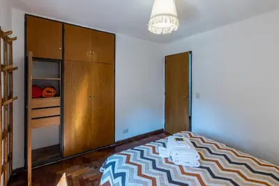 a bedroom with a bed and wooden cabinets at Alójate en la Docta by Lofty in Cordoba
