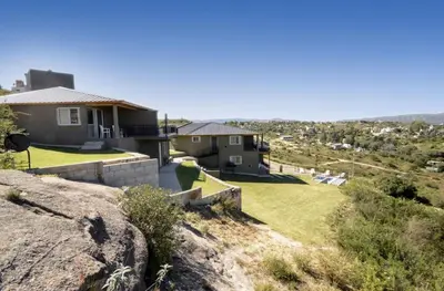 a house on the side of a hill at Complejo Lamarca in Villa Carlos Paz