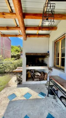 a fireplace in the side of a house at Departamento con vista a las sierras en Planta Alta para 2 a 4 personas in Merlo