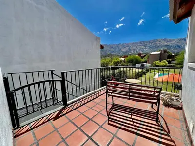 a balcony with a bench on a patio at Departamento con vista a las sierras en Planta Alta para 2 a 4 personas in Merlo