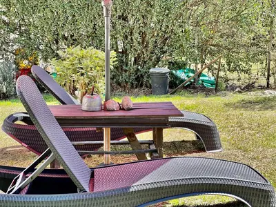 a table and chairs with a table and an umbrella at Departamento con vista a las sierras en Planta Alta para 2 a 4 personas in Merlo