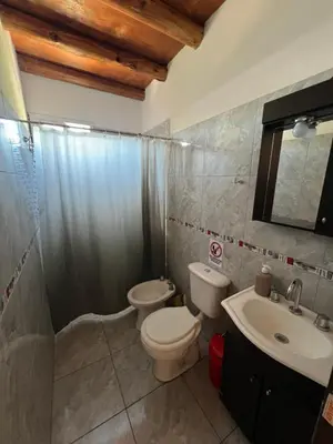 a bathroom with a toilet and a sink at Dpto Evelyn in Villa Cura Brochero