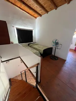 a room with a table and a fan in a room at Dpto Evelyn in Villa Cura Brochero