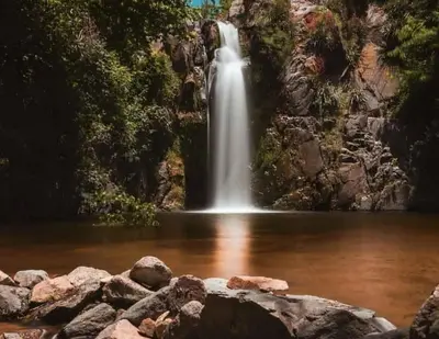 a waterfall in the middle of a body of water at Villa Somena in Tanti