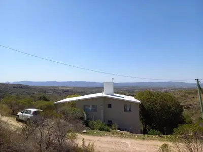 a white house with a truck parked in front of it at Villa Somena in Tanti