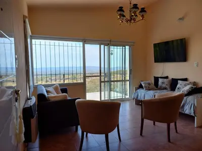 a living room with a bed and a couch and chairs at Villa Somena in Tanti