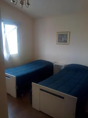 a bedroom with two beds and a window at Villa Somena in Tanti