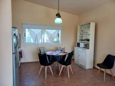 a kitchen and dining room with a table and chairs at Villa Somena in Tanti
