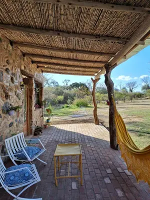 a patio with chairs and a hammock on a house at Vayu- en La Casa de Nanda in San Javier