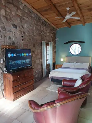 a bedroom with a bed and a flat screen tv at Vayu- en La Casa de Nanda in San Javier