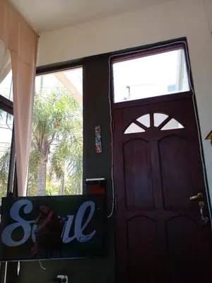 a black door with a sign in front of it at Casa Maravilla in Villa Carlos Paz