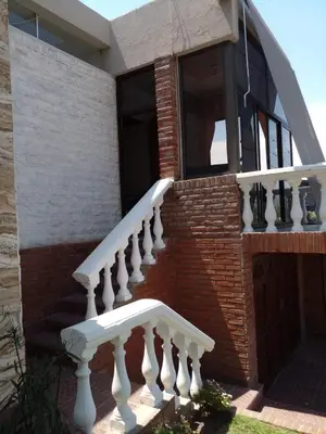 a white staircase on the side of a house at Casa Maravilla in Villa Carlos Paz