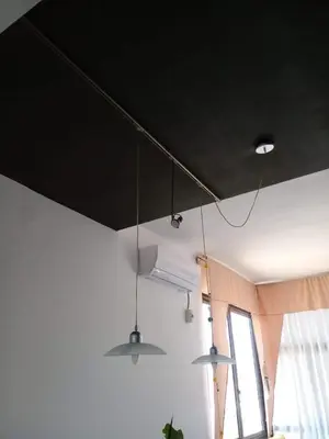 a room with three lights hanging from the ceiling at Casa Maravilla in Villa Carlos Paz
