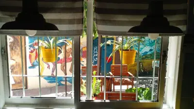 a window with two potted plants on it at Casa Maravilla in Villa Carlos Paz