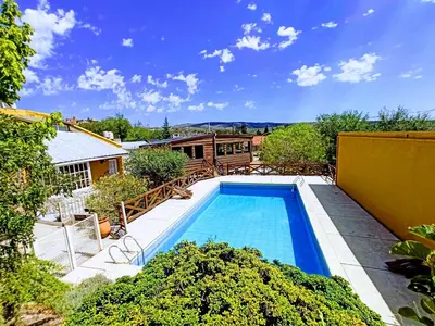 a swimming pool in the middle of a yard at Complejo El Alto in Tanti