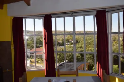 a room with a large window with a view at Complejo El Alto in Tanti