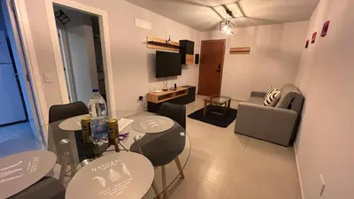 a room with two tables and chairs and a living room at Guesthouse Park in Cordoba