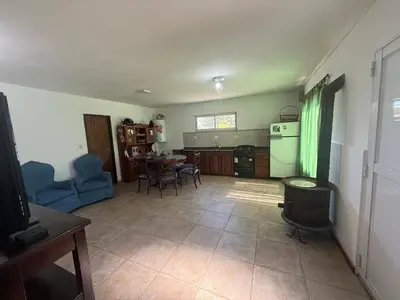a living room with a kitchen and a dining room at El Rincon de las Marias in San Lorenzo