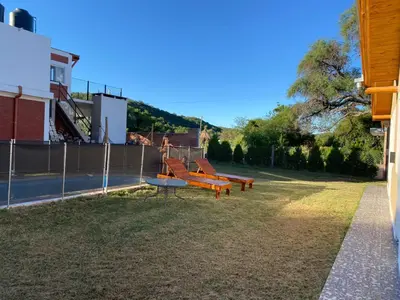 a playground with orange benches in a yard at El Rincon de las Marias in San Lorenzo