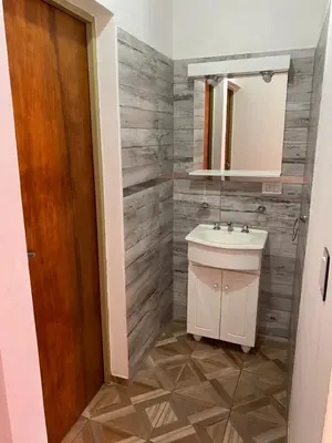 a bathroom with a sink and a mirror at El Rincon de las Marias in San Lorenzo
