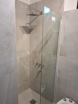a shower with a glass door in a bathroom at Moderno Departamento B° Urca P/ 4 Personas in Cordoba