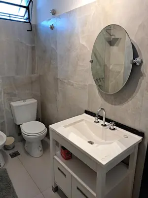 a bathroom with a sink and a toilet and a mirror at Moderno Departamento B° Urca P/ 4 Personas in Cordoba