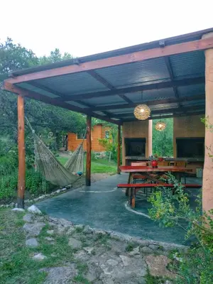 a pavilion with a hammock and a picnic table at Del Sol a la Montaña EcoLodge - Turismo Consciente in Potrero de Garay