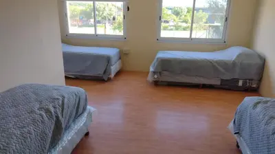 a room with three beds and two windows at Dulce Refugio in Cortaderas