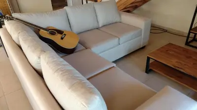 a guitar sitting on a couch in a living room at Dulce Refugio in Cortaderas