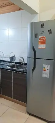 a kitchen with a stainless steel refrigerator and a sink at Dulce Refugio in Cortaderas