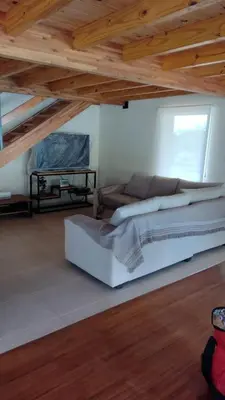 a bedroom with a bed in a room with wooden ceilings at Dulce Refugio in Cortaderas