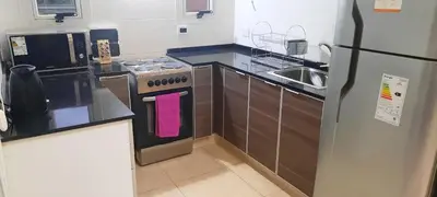 a kitchen with a stove and a refrigerator at Dulce Refugio in Cortaderas