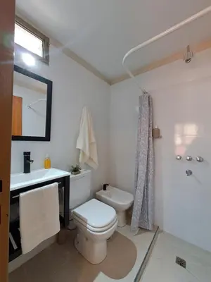 a white bathroom with a toilet and a sink at Tu lugar en Nueva Córdoba!A 50 mtros del Sanatorio Acongagua in Cordoba