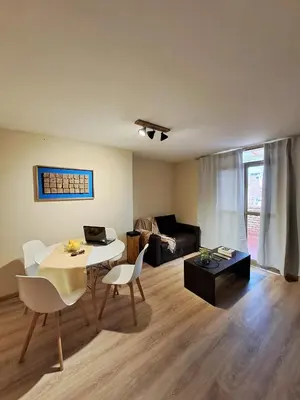a living room with a table and chairs and a couch at Tu lugar en Nueva Córdoba!A 50 mtros del Sanatorio Acongagua in Cordoba