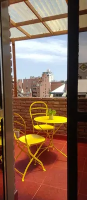 a yellow table and chairs on a balcony at Tu lugar en Nueva Córdoba!A 50 mtros del Sanatorio Acongagua in Cordoba