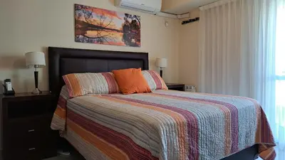 a bedroom with a bed with a colorful blanket at ESPACIO C CRISOL Plaza España in Cordoba