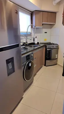 a kitchen with a stainless steel refrigerator and a dishwasher at ESPACIO C CRISOL Plaza España in Cordoba