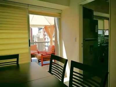 a dining room with a table and chairs and a balcony at ESPACIO C CRISOL Plaza España in Cordoba